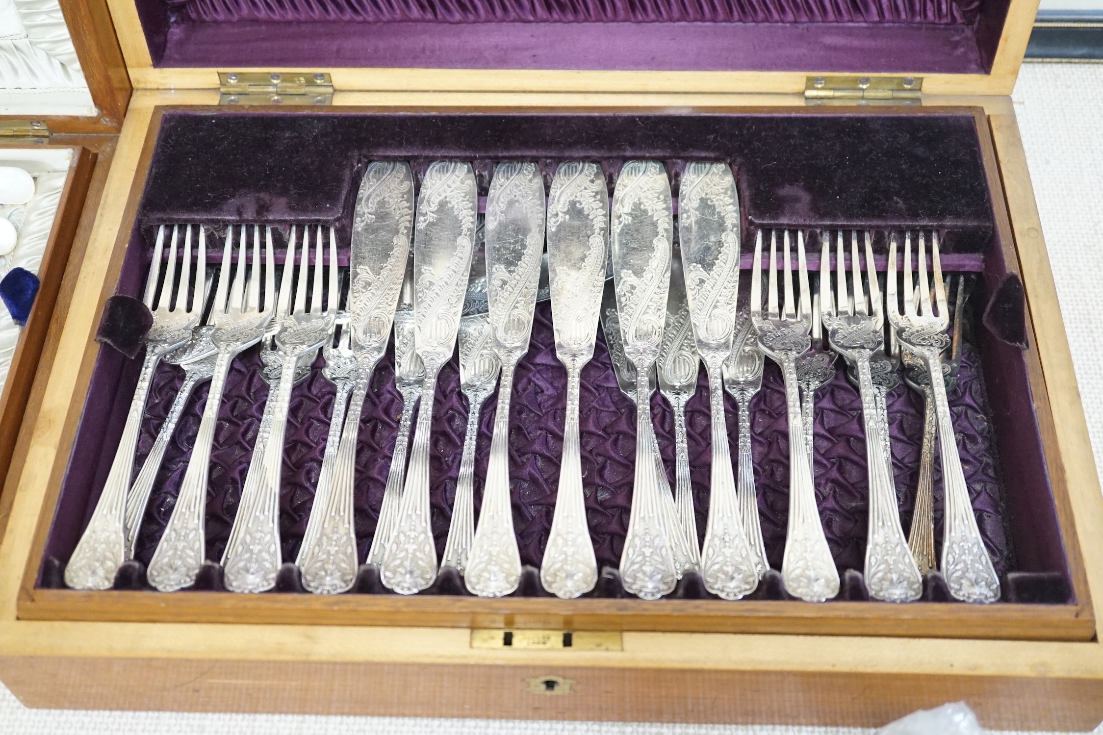 Two cased electroplate sets: a set of twelve fruit eaters and twelve fish knives and forks